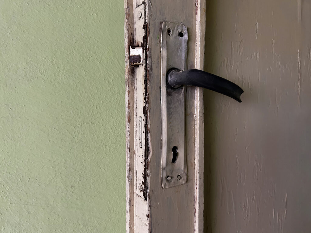 Close-up of moisture-damaged door trim in an older home